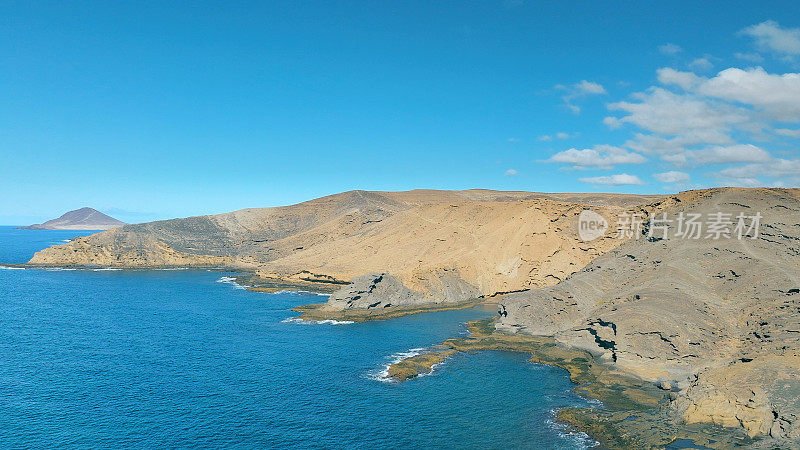 Aerial view of the beach "Playa Escondida" and the natural reserve of "Montaña Pelada" in Tenerife (Canary Islands). Drone shot